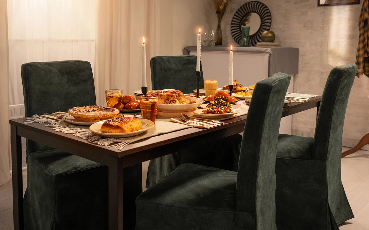 Beautifully decorated dining space featuring four IKEA Harry dining chairs with machine washable and spill-resistant Signature Velvet Bayleaf covers