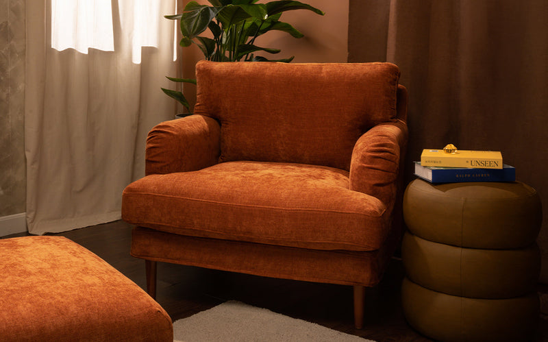 An IKEA Stocksund armchair with a machine washable and wrinkle free Performance Weave Burnt Orange cover in a decorated living room