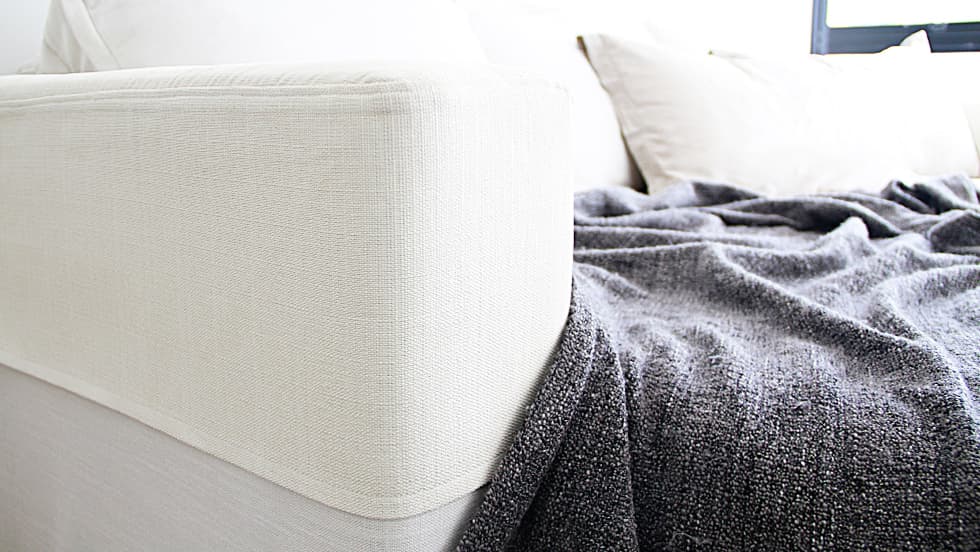 Sofa armrest with custom made Everyday Linen cream protector cover