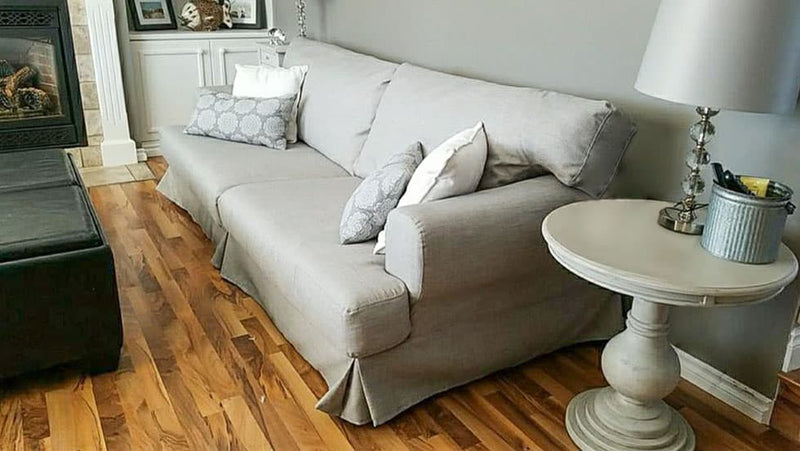 A light grey Hovas sofa in a predominantly grey, stylish living room