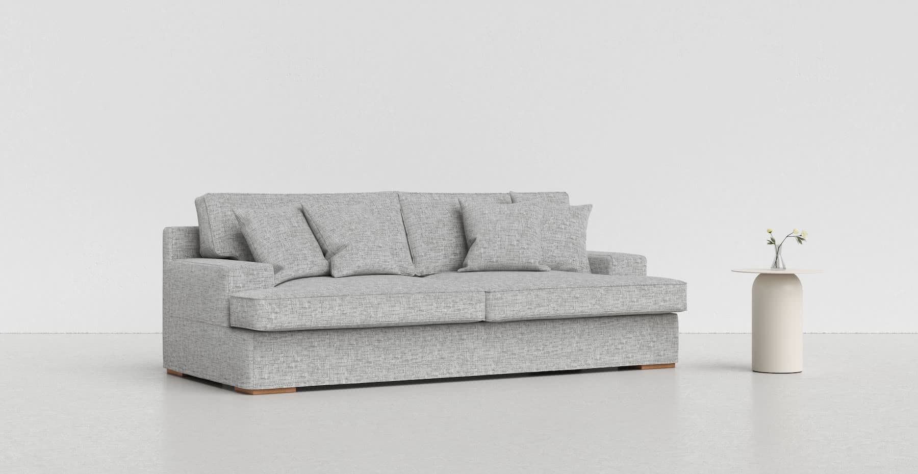 A medium grey Goteborg sofa on a lighter grey background with a white vase beside it