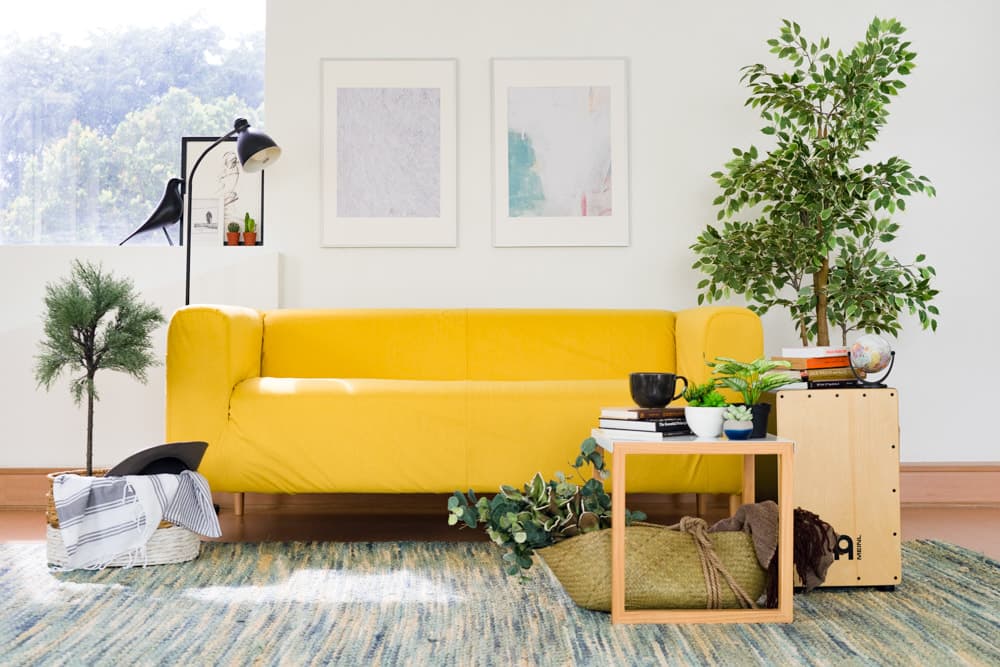 Bright yellow Klippan two seater sofa in a peaceful, minimalist living room