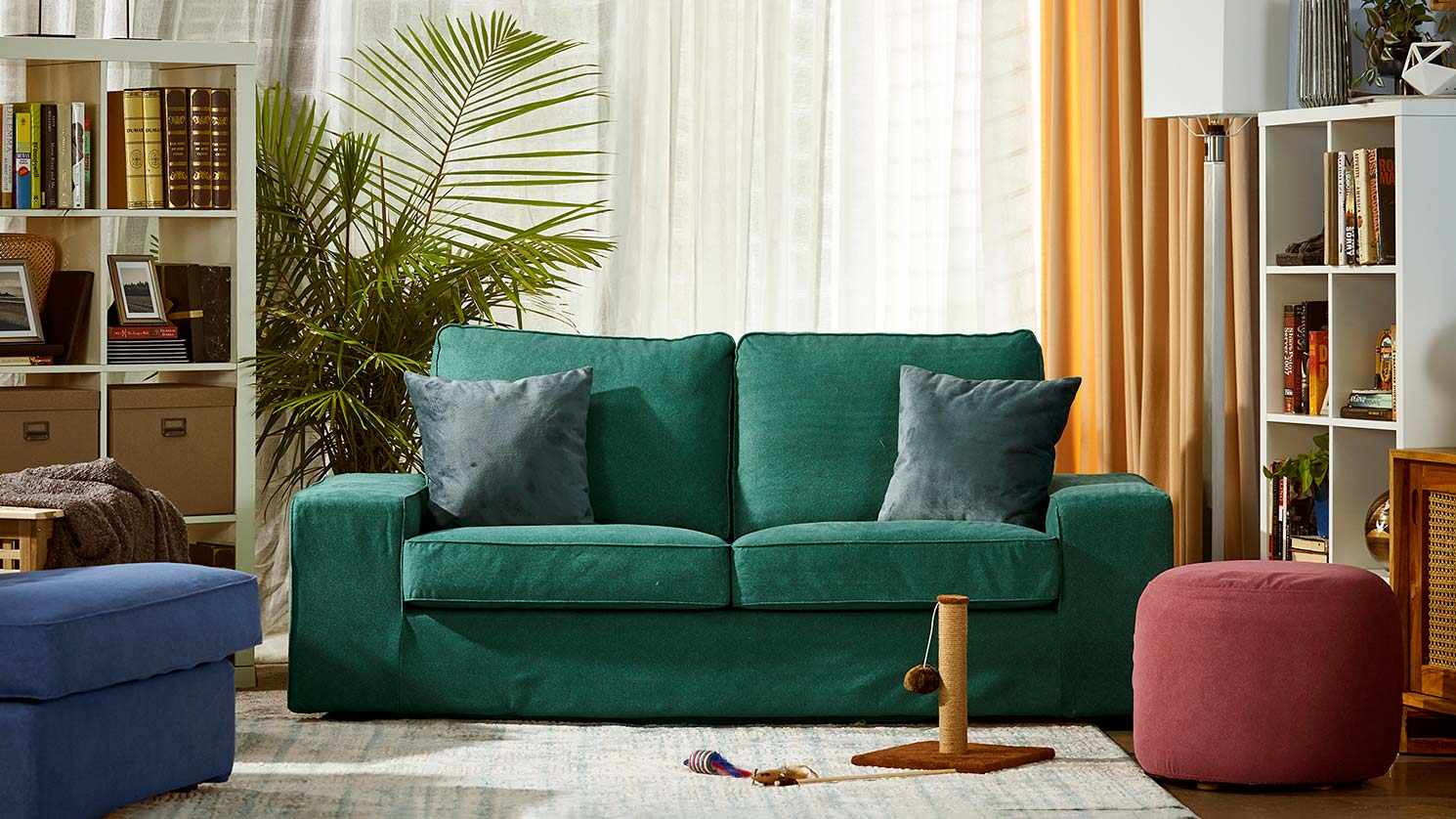 An IKEA Kivik sofa in a forest green Classic Velvet cover in a colourful family living room