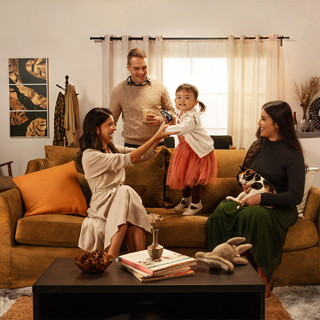 Warm family gathering on a Signature Velvet sofa slipcover from Comfort Works, featuring cosy custom couch covers for a stylish and inviting living space