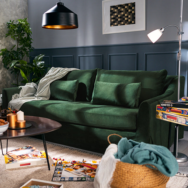 Cosy living room with a deep green sofa slipcover from Comfort Works, featuring custom couch covers for a stylish and inviting space