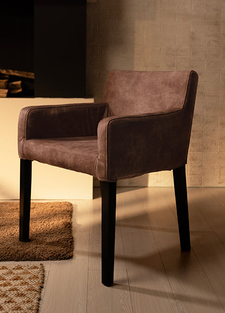 Elegant brown armchair slipcover with a sleek design, blending seamlessly into a warm and modern living space