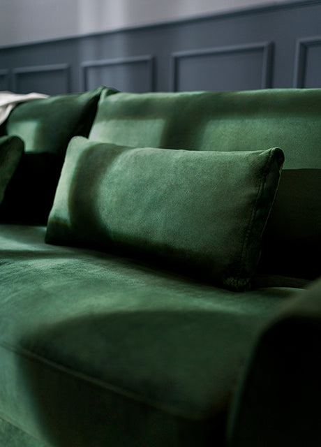 Close-up of a deep green sofa slipcover from Comfort Works, showcasing plush fabric and custom couch covers for a luxurious, tailored look