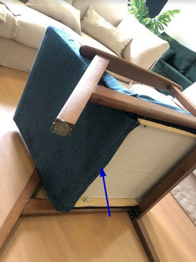 Image: Armchair slipcover guide, blue arrow indicating where to secure the new cover velcro at the bottom of the chair