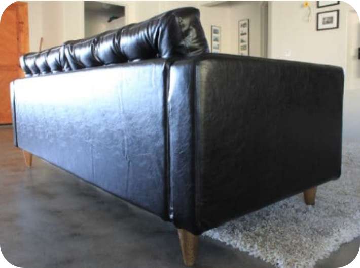 Back view of a sofa couch with Bycast Leather Urbanskin Kramfors slipcover