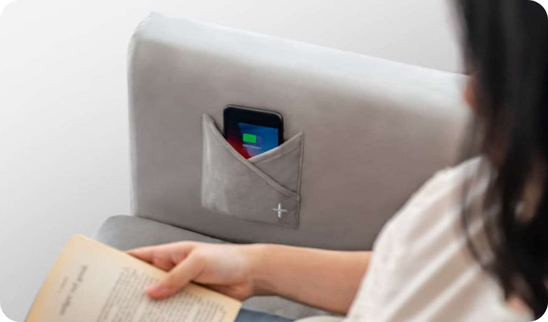 Close-up of mobile phone charging on the sofa smart accessories slipcover