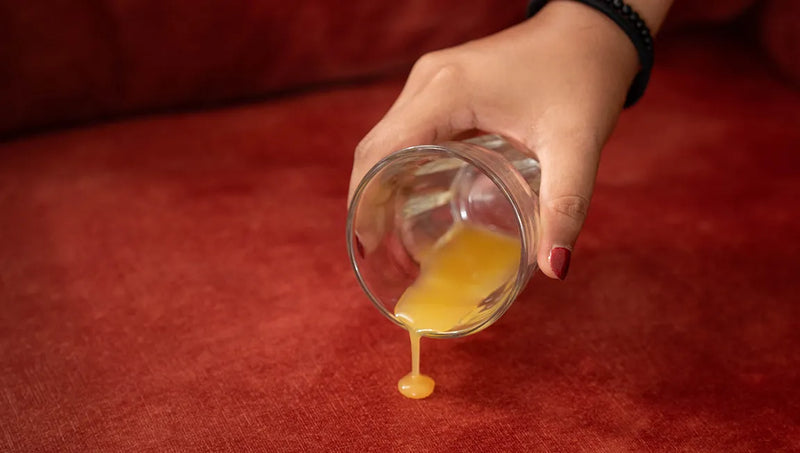 Spilling-orange-drink-on-sofa-with-ComfortWorks-performance-fabric-couch-cushion-cover-Signature-Velvet-in-Sunset-colour