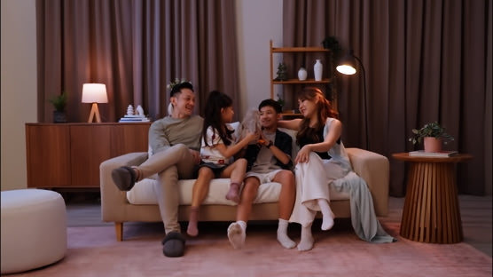 Family-of-four-parents-with-children-spending-time-at-home-on-their-living-room-couch-with-ComfortWorks-FlexiFit-universal-couch-covers