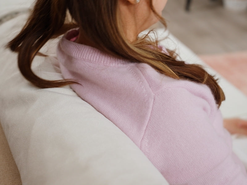 Back-view-of-lady-seated-firmly-only-her-living-room-couch-fitted-with-ComfortWorks-FlexiFit-universal-couch-cushion-cover