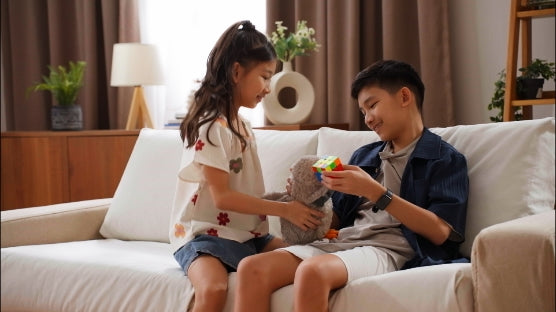 Kids-siblings-playing-together-on-their-home-living-room-couch-fitted-with-ComfortWorks-FlexiFit-universal-couch-cushion-covers