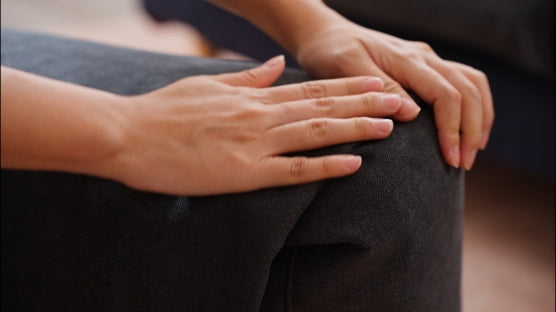 Hands-adjusting-excess-fabric-on-the-edges-of-ComfortWorks-FlexiFit-universal-sofa-cushion-cover