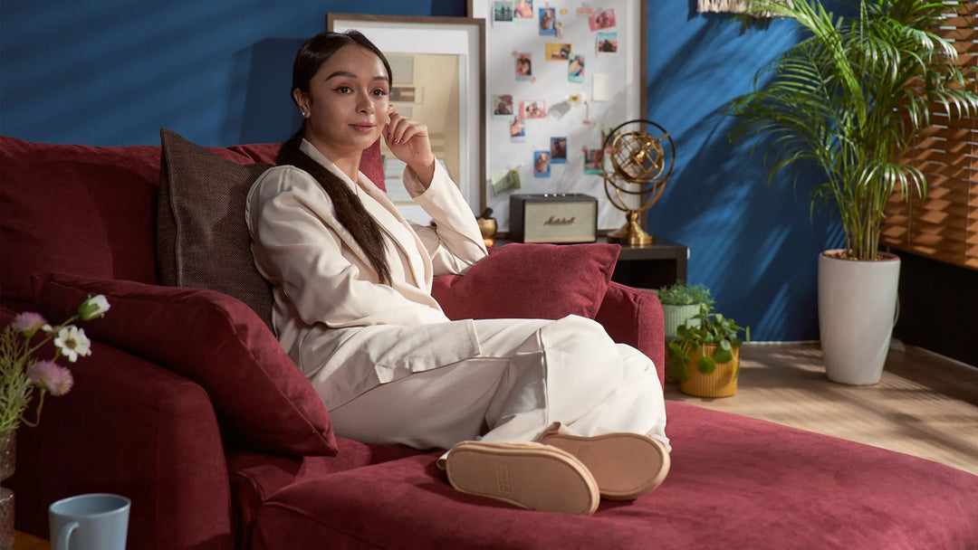 Woman-resting-at-home-on-sofa-and-ottoman-in-ComfortWorks-Everyday-Weave-couch-cover-in-Maroon