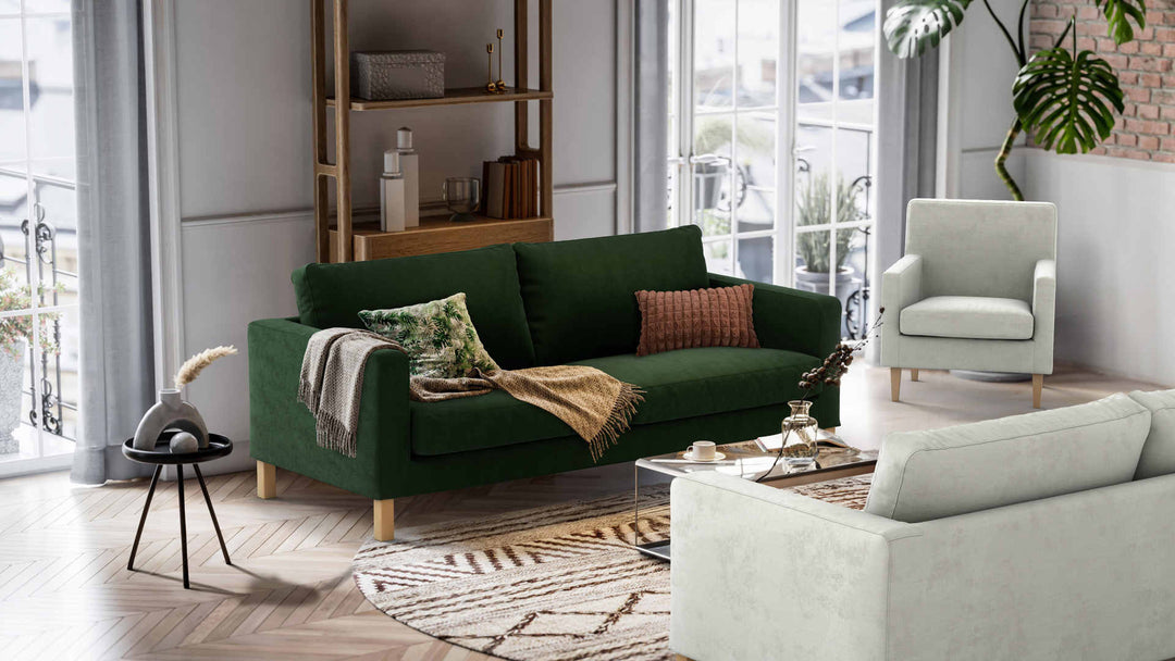 Nordic Minimalist living room with IKEA Karlstad sofa in Performance Weave Stone and Classic Velvet Forest Green slipcover