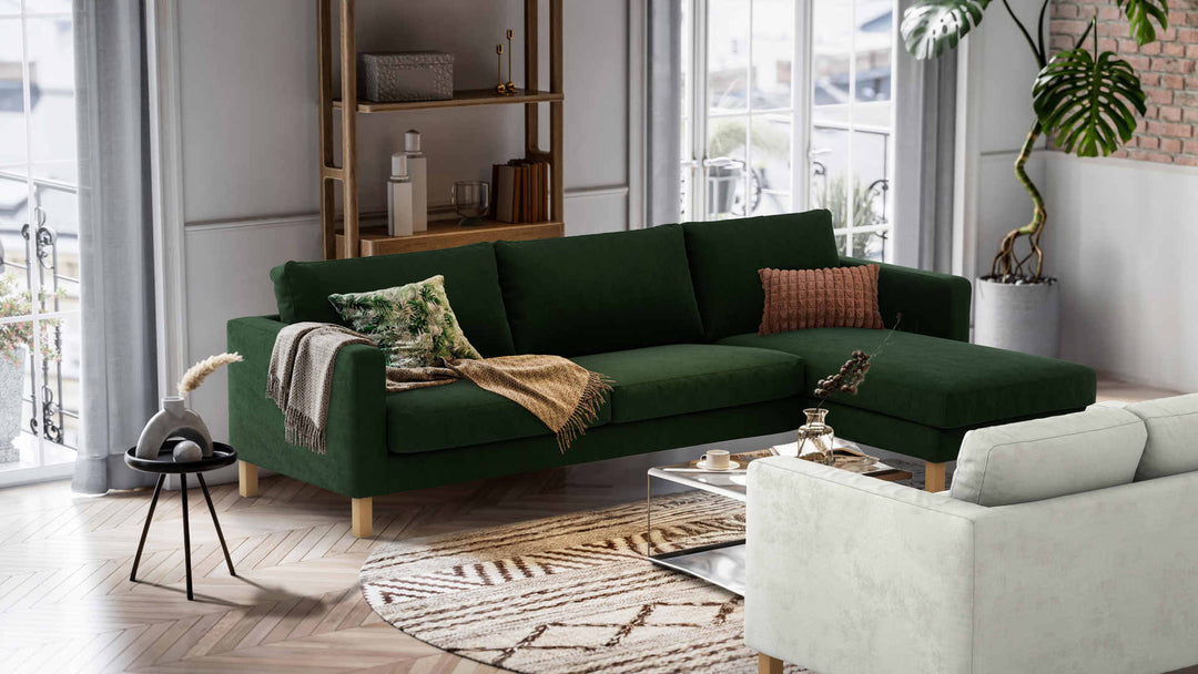 Nordic Minimalist living room with IKEA Karlstad sofa in Performance Weave Stone and Classic Velvet Forest Green slipcover