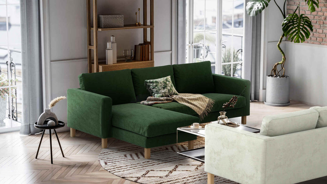Nordic Minimalist living room with IKEA Karlstad sofa in Performance Weave Stone and Classic Velvet Forest Green slipcover
