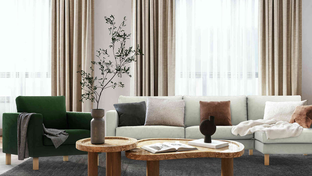 Modern living room with IKEA Karlstad sofa in Performance Weave Stone and Classic Velvet Forest Green slipcover