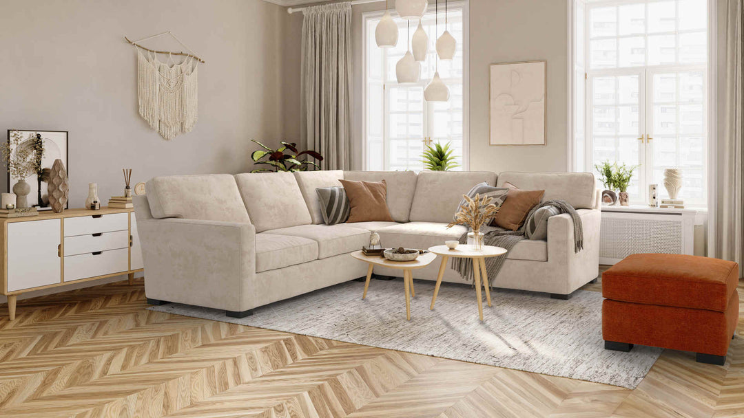 Scandinavian living room with Crate and Barrel Axis II sofa in Performance Weave Cream and Comfort Chenille Burnt Orange slipcover