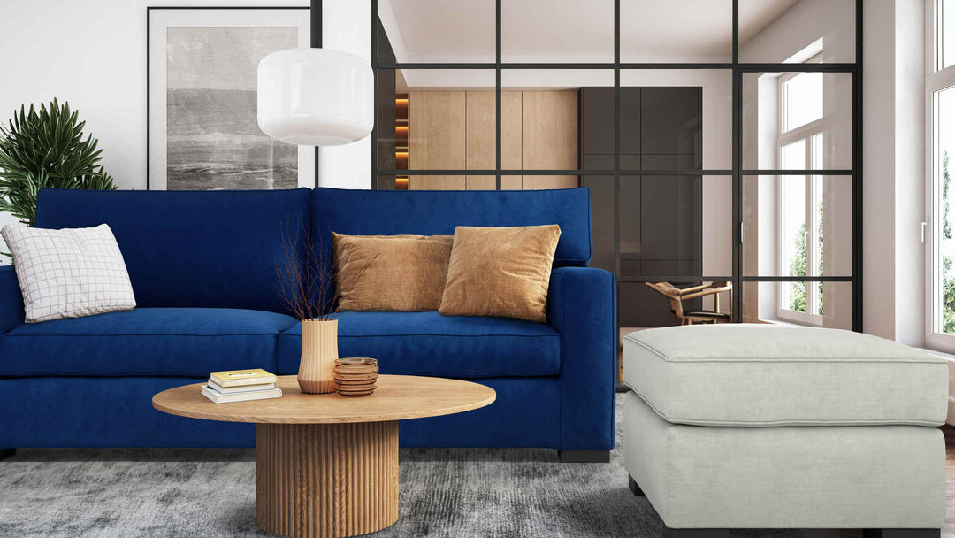 Modern living room with Crate and Barrel Axis II sofa in Classic Velvet Cobalt and Performance Weave Stone slipcover