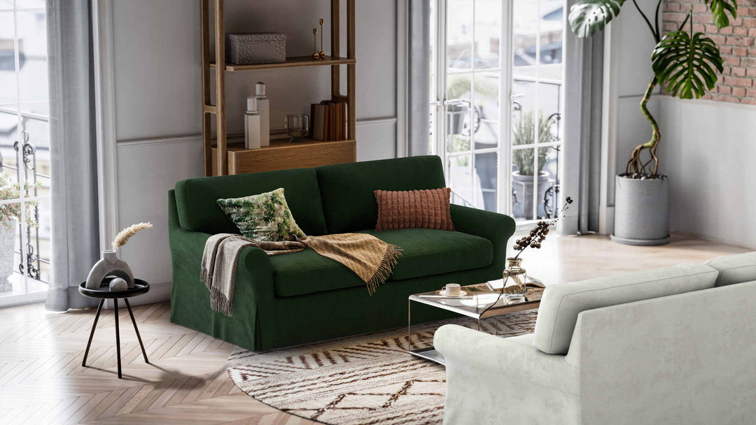 Nordic Minimalist living room with Crate and Barrel Potomac sofa in Performance Weave Stone and Classic Velvet Forest Green slipcover