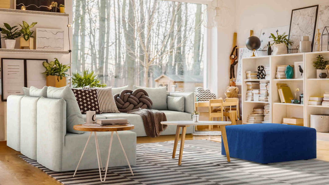 Bohemian living room with Elbgestoeber Elbdock sofa in Performance Weave Stone and Classic Velvet Cobalt slipcover