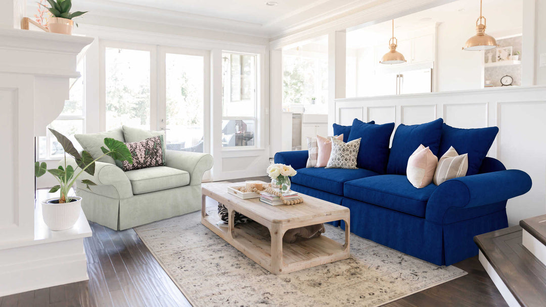 Modern Victorian living room with Pottery Barn Charleston sofa in Classic Velvet Cobalt and Performance Weave Stone slipcover