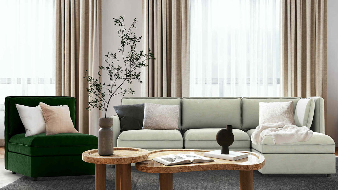Modern living room with IKEA Vallentuna sofa in Performance Weave Stone and Classic Velvet Forest Green slipcover