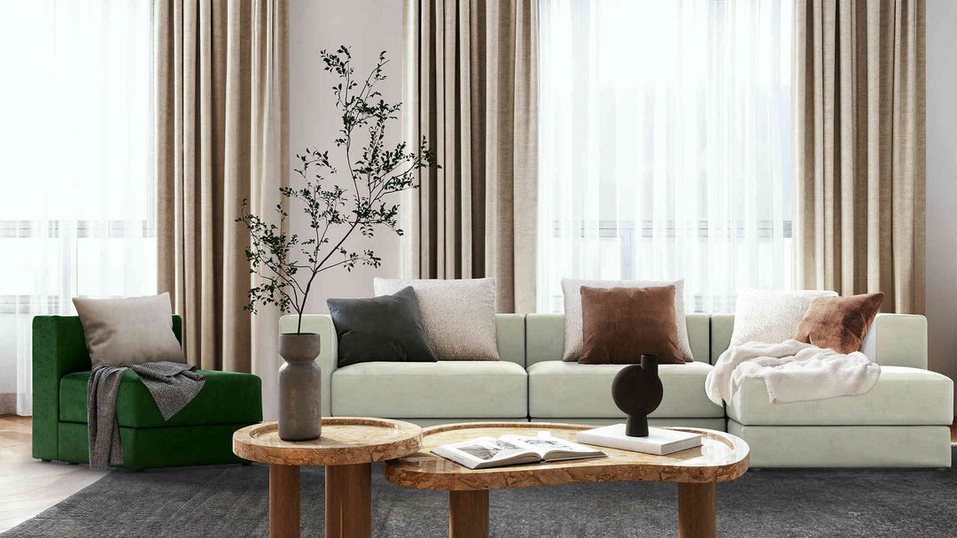 Modern living room with IKEA Jattebo sofa in Performance Weave Stone and Classic Velvet Forest Green slipcover
