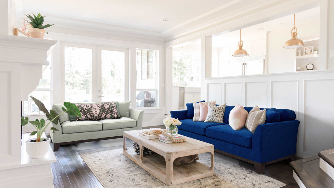 Modern Victorian living room with Pottery Barn Greenwich sofa in Classic Velvet Cobalt and Performance Weave Stone slipcover