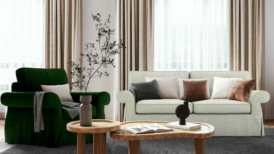 Modern living room with Pottery Barn Pearce Roll Arm sofa in Performance Weave Stone and Classic Velvet Forest Green slipcover