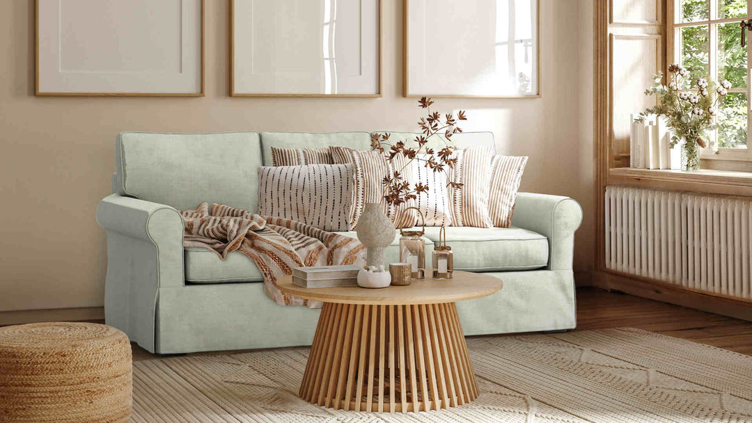Nordic Minimalist living room with Pottery Barn Buchanan Roll Arm sofa in Performance Weave Stone slipcover