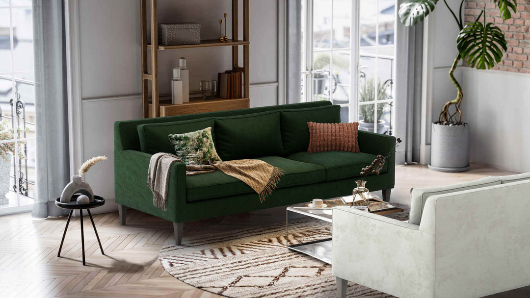 Nordic Minimalist living room with Crate and Barrel Rochelle Midcentury sofa in Performance Weave Stone and Classic Velvet Forest Green slipcover