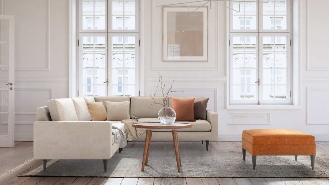 Modern Victorian living room with Crate and Barrel Petrie Midcentury sofa in Performance Weave Cream and Comfort Chenille Burnt Orange slipcover