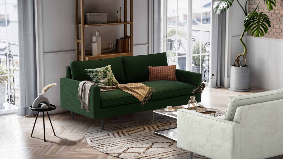 Nordic Minimalist living room with Crate and Barrel Petrie Midcentury sofa in Performance Weave Stone and Classic Velvet Forest Green slipcover