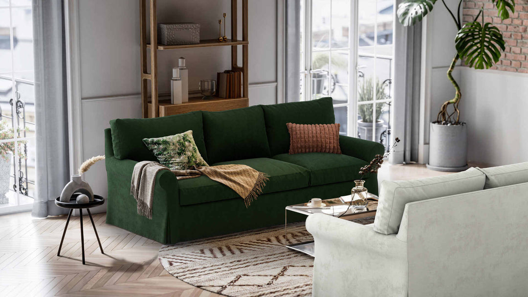 Nordic Minimalist living room with Crate and Barrel Potomac sofa in Performance Weave Stone and Classic Velvet Forest Green slipcover