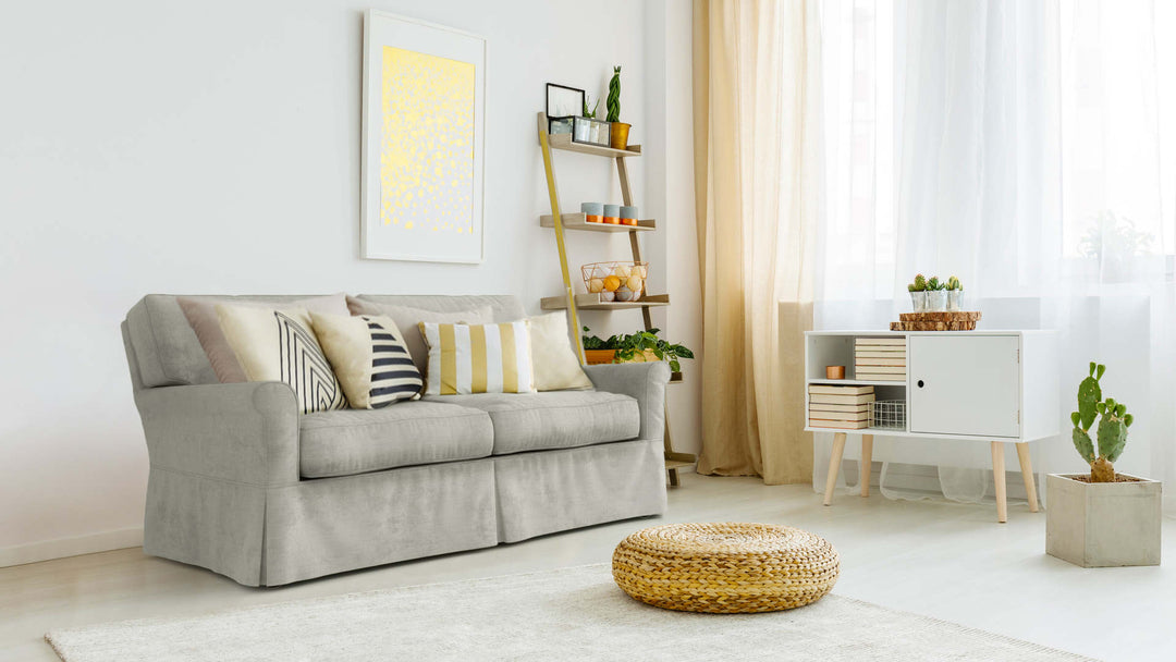 Bohemian living room with Crate and Barrel Bayside sofa in Performance Weave Stone fabric slipcover
