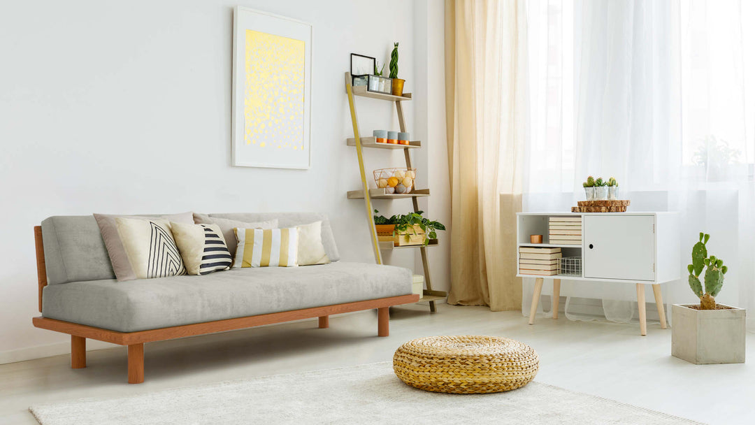 Bohemian living room with Muji Wooden Sofa Bed in Performance Weave Stone fabric slipcover