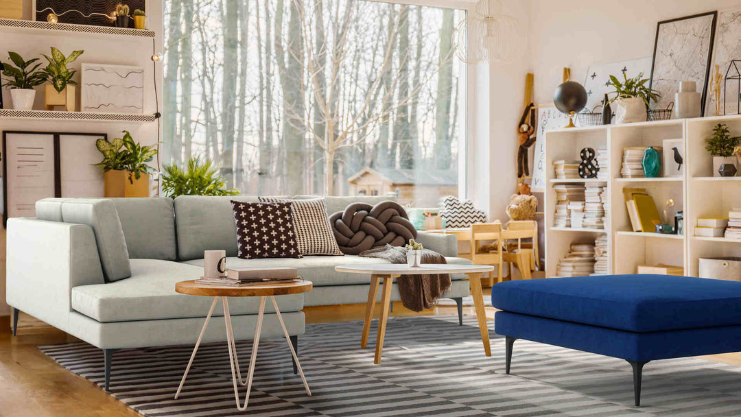 Bohemian living room with West Elm Andes sofa in Performance Weave Stone and Classic Velvet Cobalt slipcover