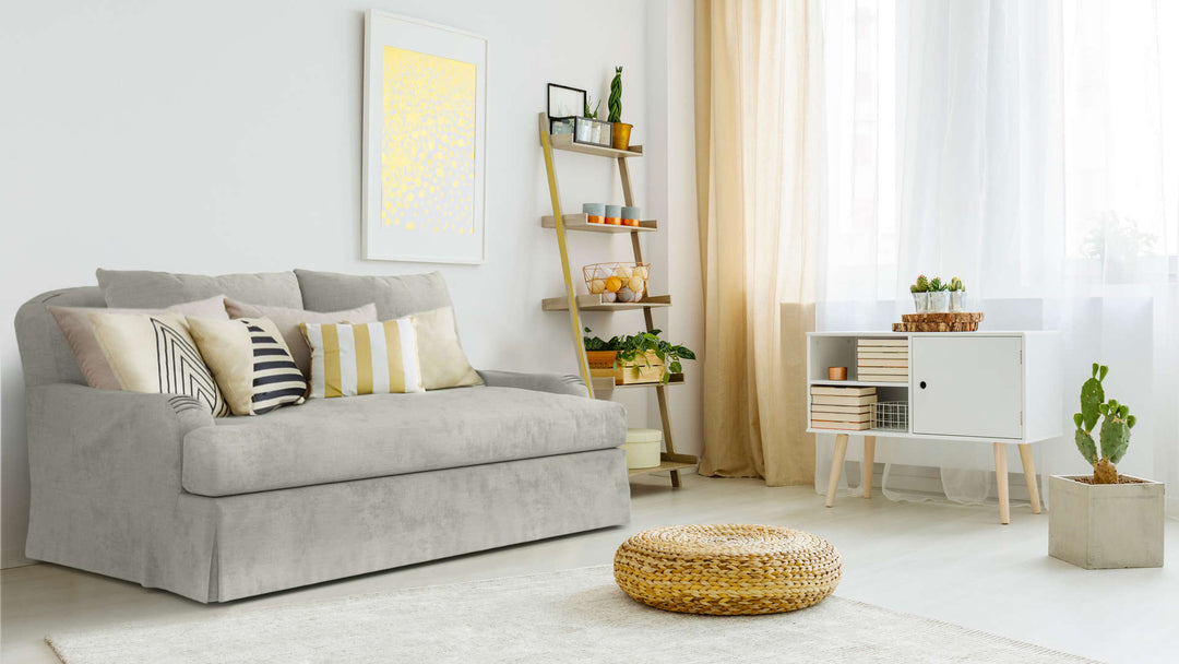 Bohemian living room with Restoration Hardware Belgian Classic Roll Arm sofa in Performance Weave Stone fabric slipcover