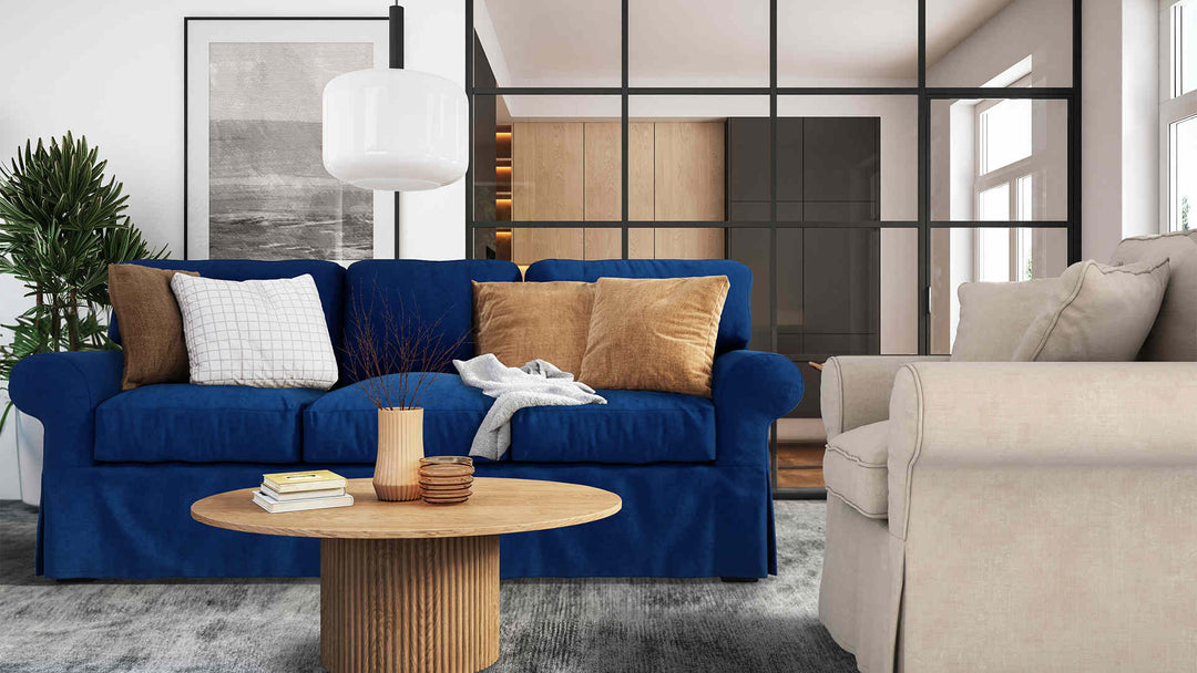 Modern living room with Maison du Monde Butterfly sofa in Classic Velvet Cobalt and Performance Weave Cream slipcover