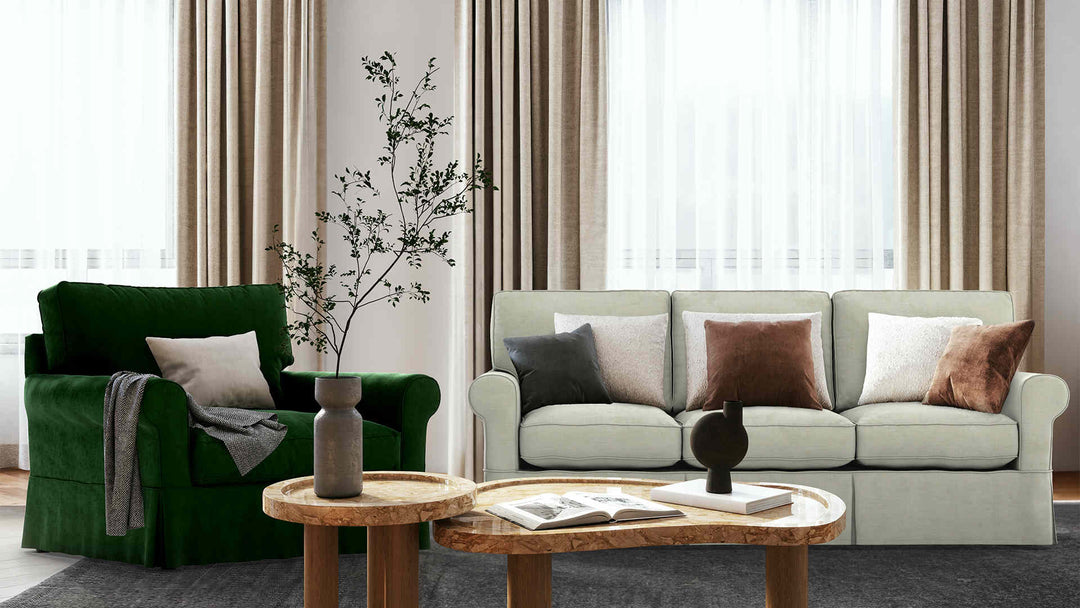 Modern living room with Arhaus Baldwin sofa in Performance Weave Stone and Classic Velvet Forest Green slipcover