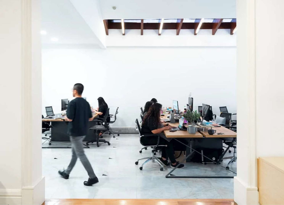 Office space with people focused on work (Alternate angle)