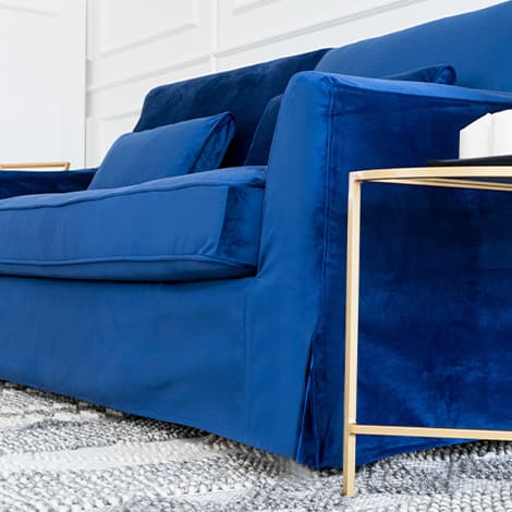 Close-up of IKEA FARLOV three-seater sofa couch skirting with Classic Velvet Cobalt slipcover