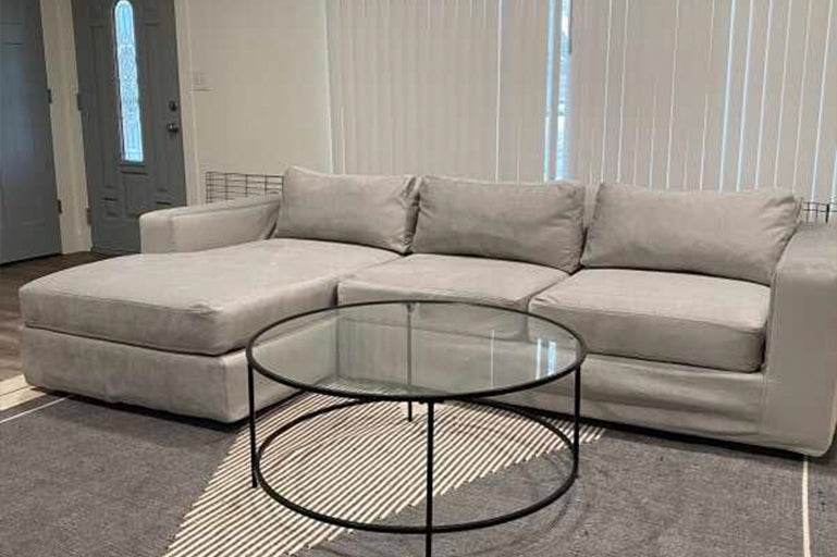 Minimalist living room with a light grey sofa slipcover from Comfort Works, featuring custom couch covers for a sleek, modern, and protective finish