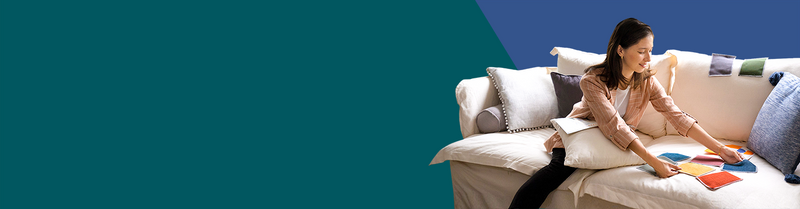 Woman arranging fabric sample swatches on the sofa to find the perfect match