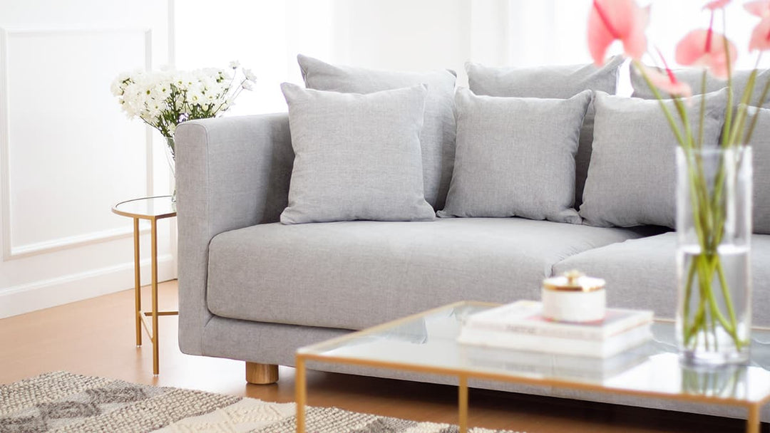 Close-up of IKEA STOCKHOLM sofa couch with Textured Weave Ash slipcover in a minimalist living room