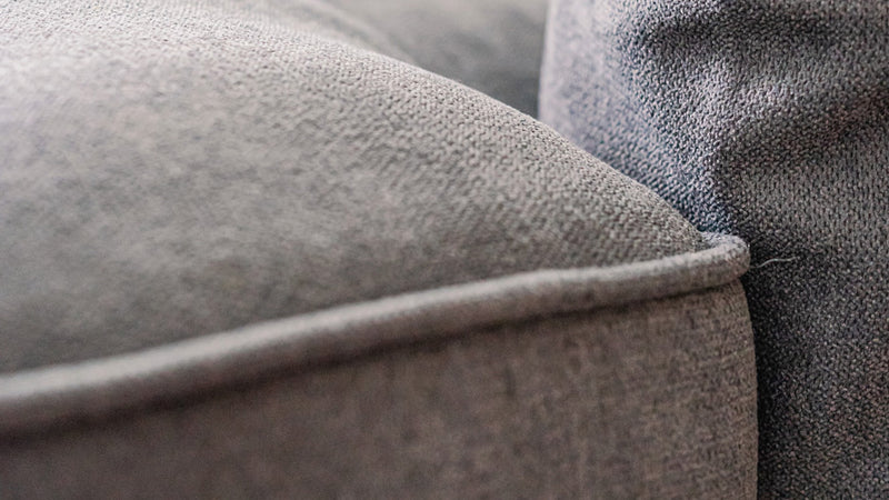 Close-up of IKEA KIVIK sofa piping with Everyday Weave Slate slipcover